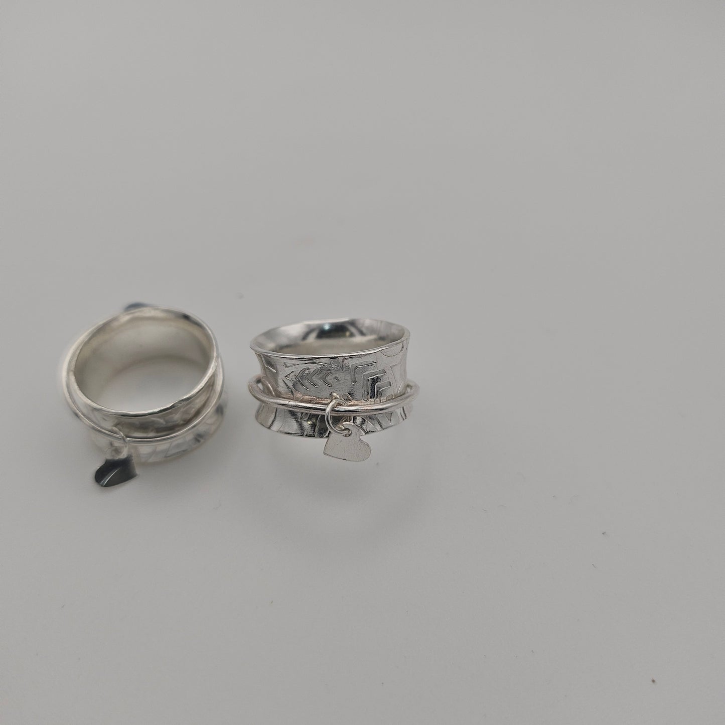 Sterling silver spinner rings. With a heart charm