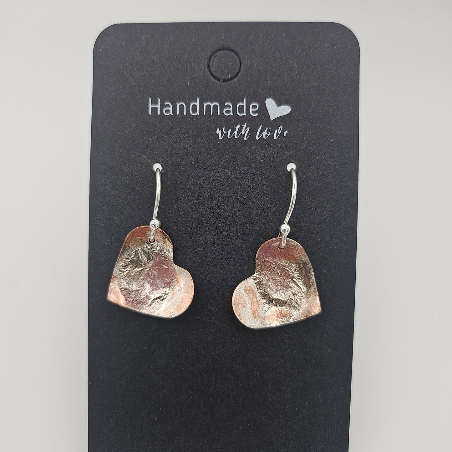 Sterling silver reticulated onto copper. Love heart earrings