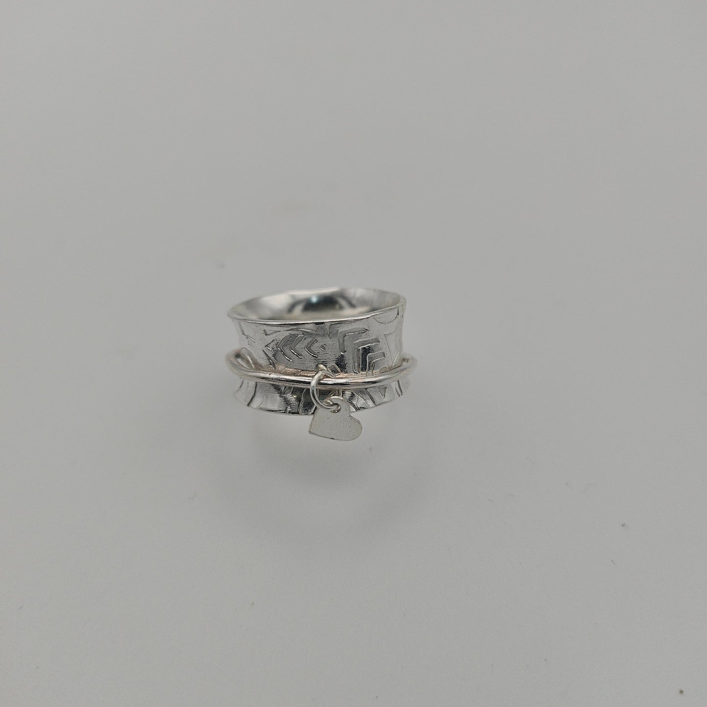 Sterling silver spinner rings. With a heart charm