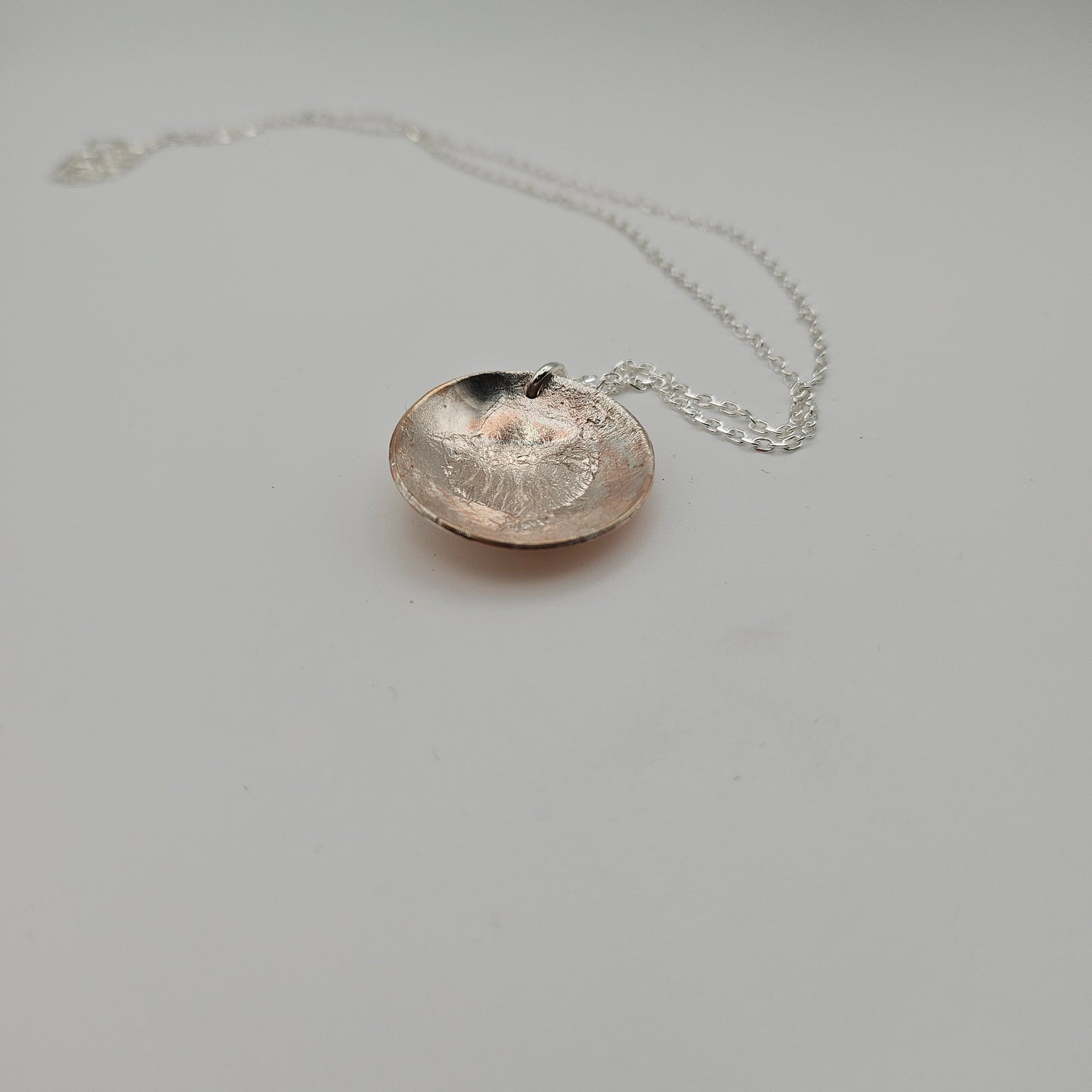 Sterling silver and copper domed round pendant