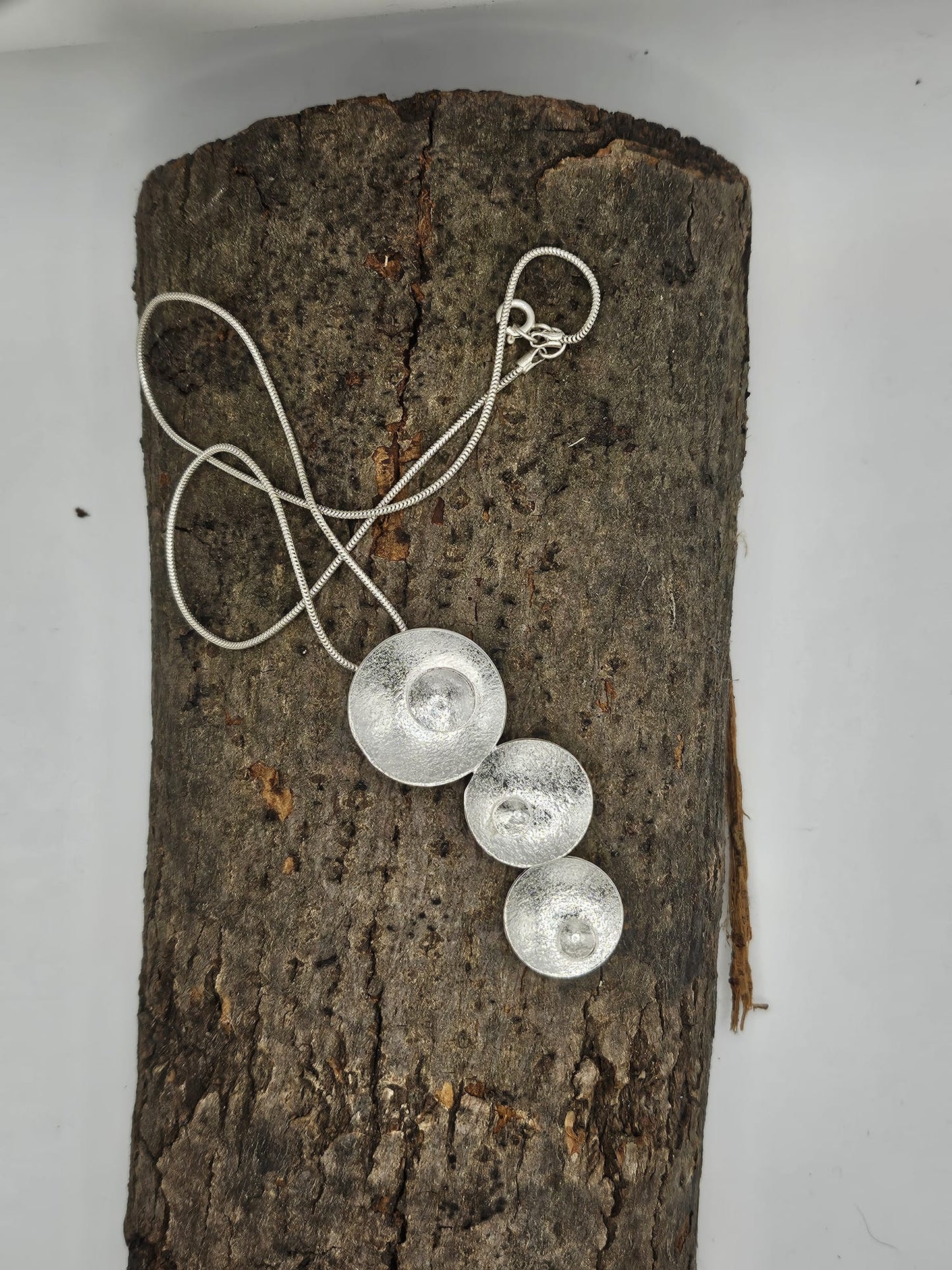 sterling silver circle drop pendant with silver circles inserted. on a snake chain