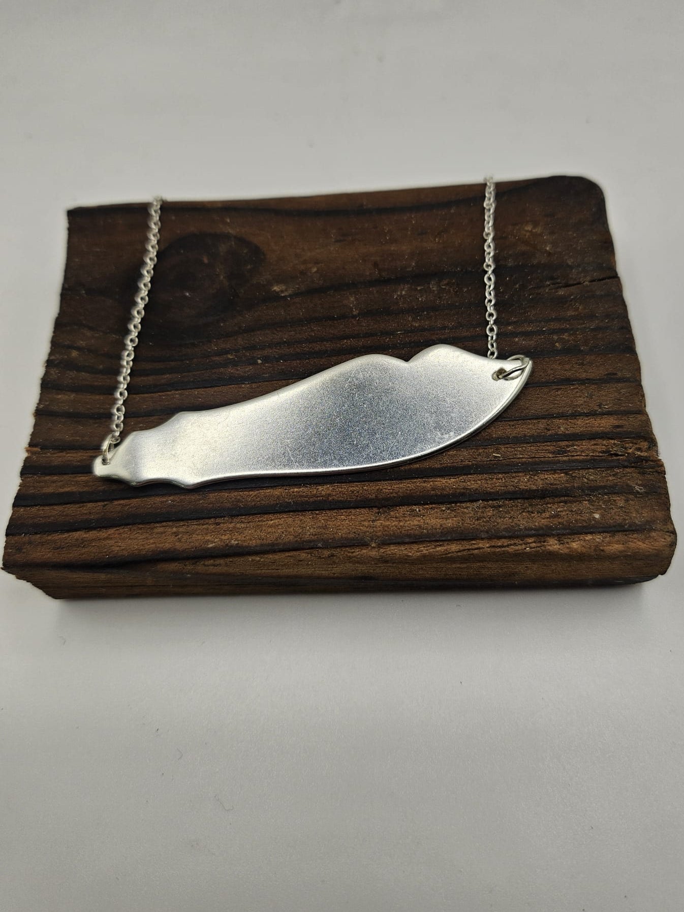 sterling silver antique fish knife pendant attached to a sterling silver chain 